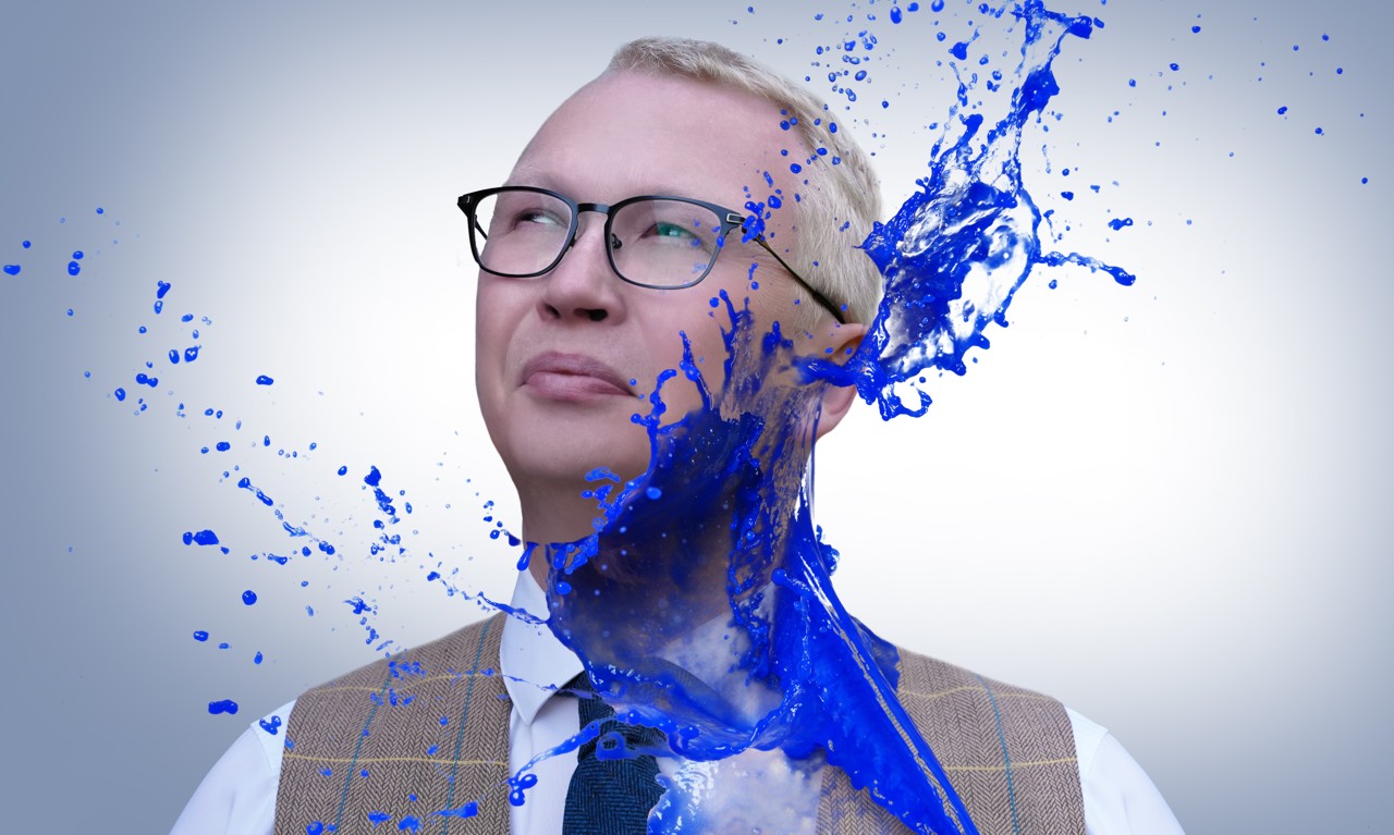 Beautiful girl and blue paint splashes on light background